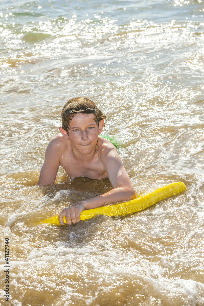 boy has fun surfing in the waves boy has fun surfing in the waves