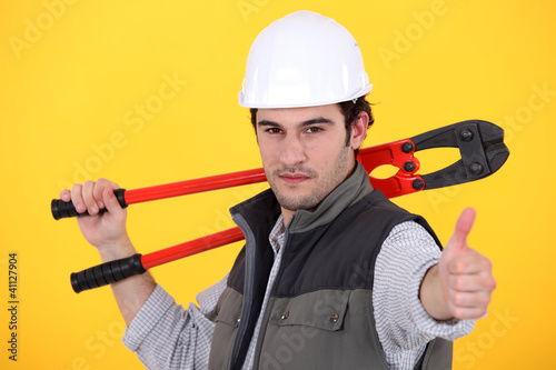 craftsman holding a spanner and making a thumbs up sign