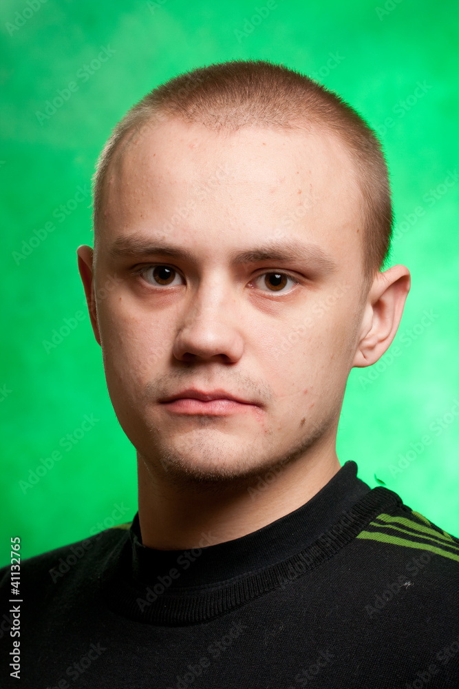 Portrait of the teenager on a green background in green clothes Portrait of the teenager on a green background in green clothes