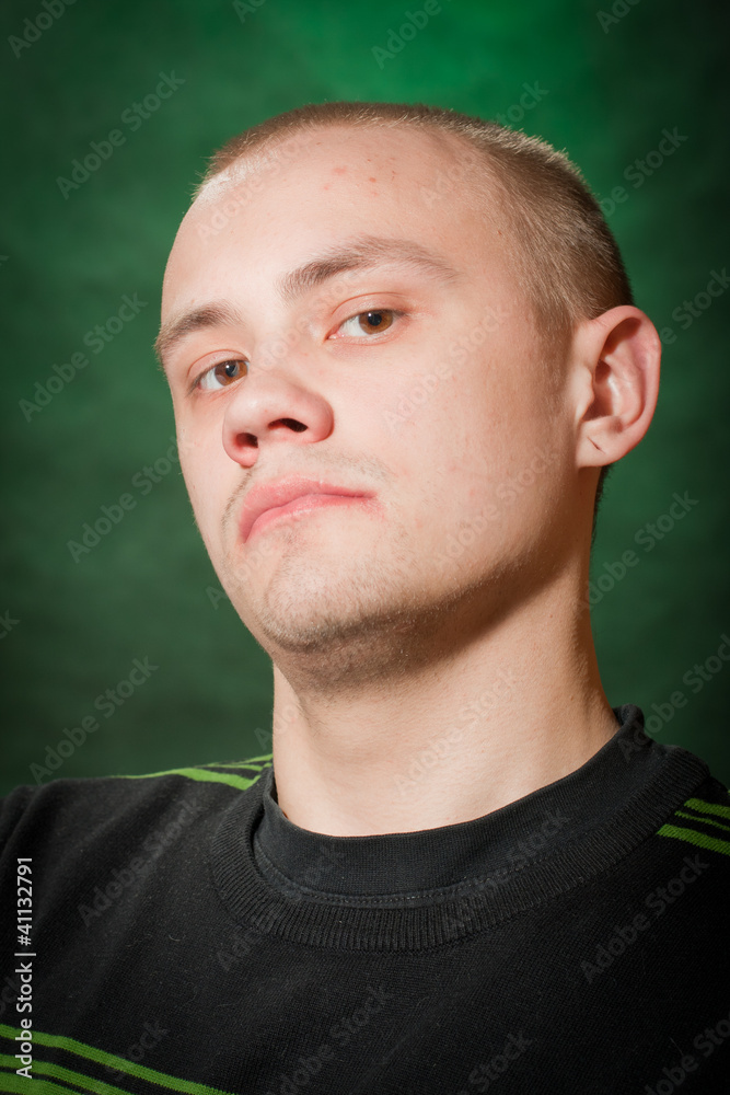Portrait of the teenager on a green background in green clothes Portrait of the teenager on a green background in green clothes