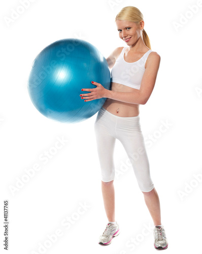 Healthy fit female athlete with a ball