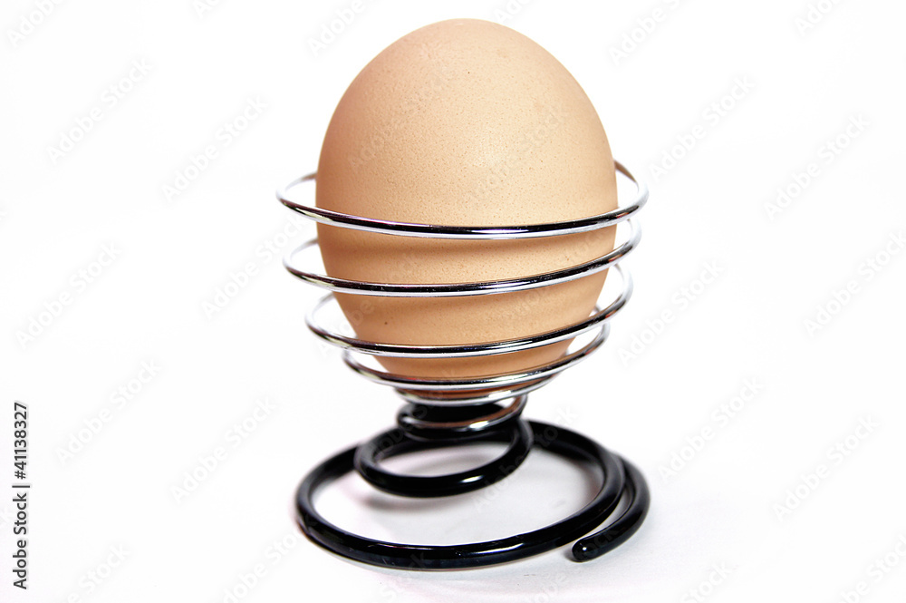 Egg in interesting stand isolated on white background Egg in interesting stand isolated on white background