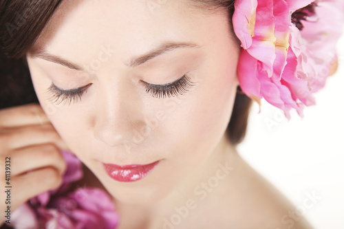 Beautiful young girl with pink flowers