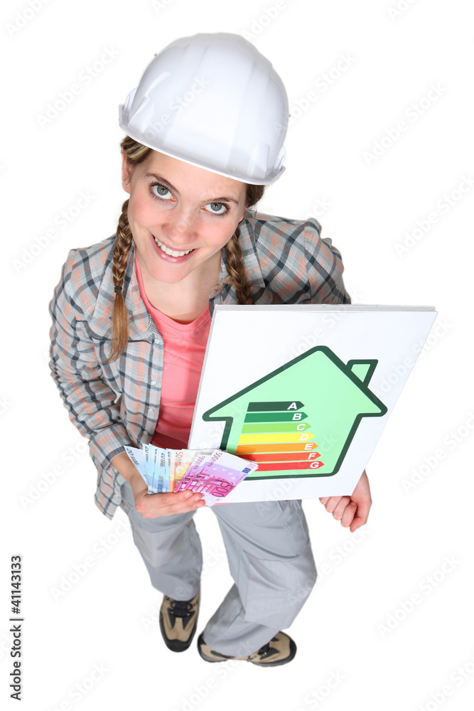 Tradeswoman holding an energy efficiency rating sign Tradeswoman holding an energy efficiency rating sign