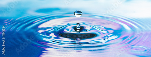 Drop of pure fresh water falls in water