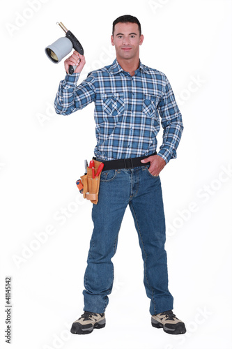 Photos Handyman holding blow torch