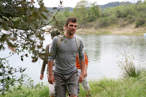 Group hiking by a lake photo