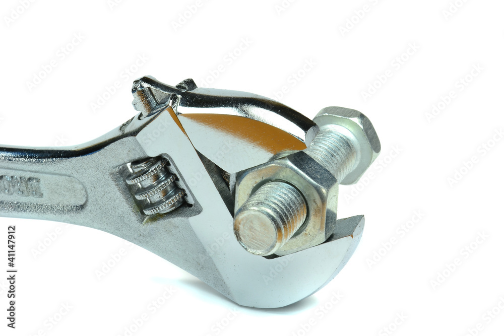 An adjustable wrench with nut and bolt on a white background An adjustable wrench with nut and bolt on a white background