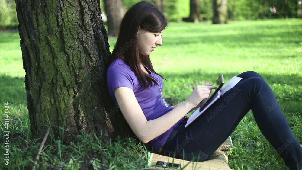 Female student with tablet computer in the park Female student with tablet computer in the park
