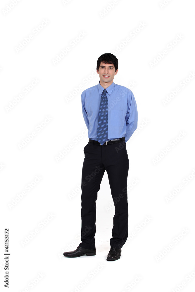businessman standing with hands in his back businessman standing with hands in his back
