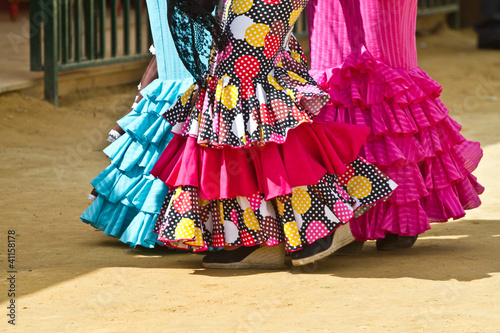 Obraz na plátně Women wearing flamenco dresses at Seville's fairground.