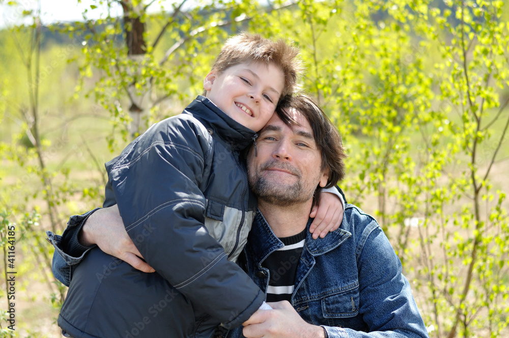 Dad and son relaxing outdoors Dad and son relaxing outdoors