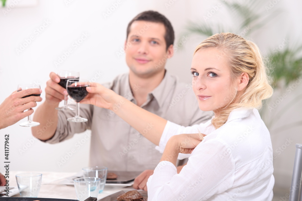 Friends making a toast at the dinner table Friends making a toast at the dinner table