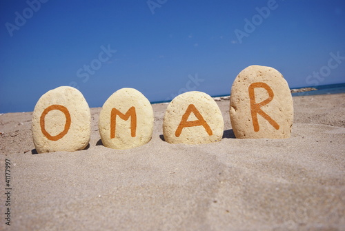 Omar , male name on colourful pebbles photo