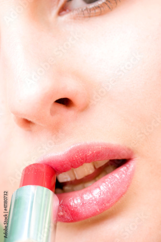 Sensual pretty woman applying cosmetics