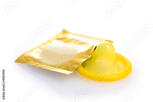 Yellow condom with  open pack isolated on white