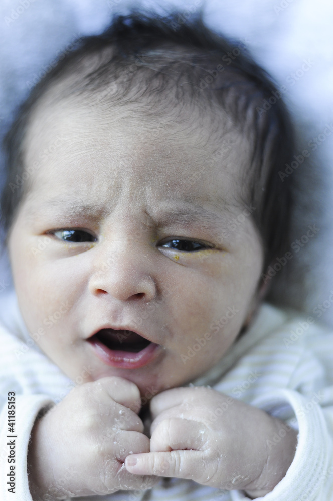 newborn baby smiling and playing with his hands newborn baby smiling and playing with his hands