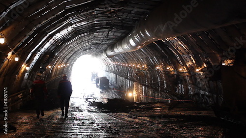 People in a tunnel. Building site.