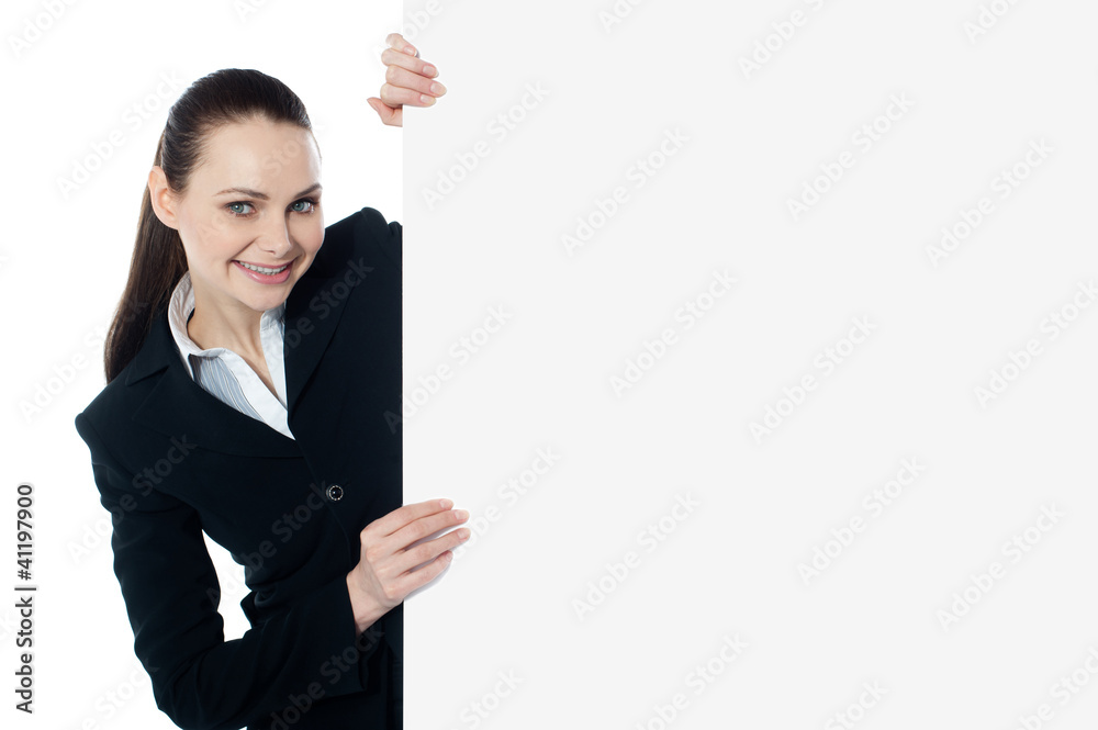 Female executive holding blank whiteboard Female executive holding blank whiteboard