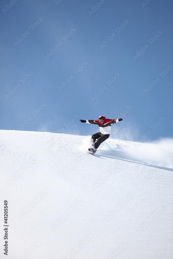 Man snowboarding down hill