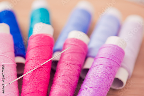 set of pink colorful sewing threads