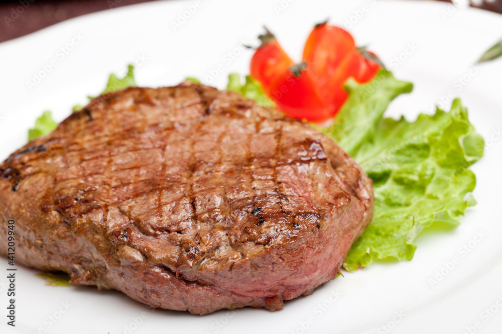 Grilled steak on a white plate Grilled steak on a white plate