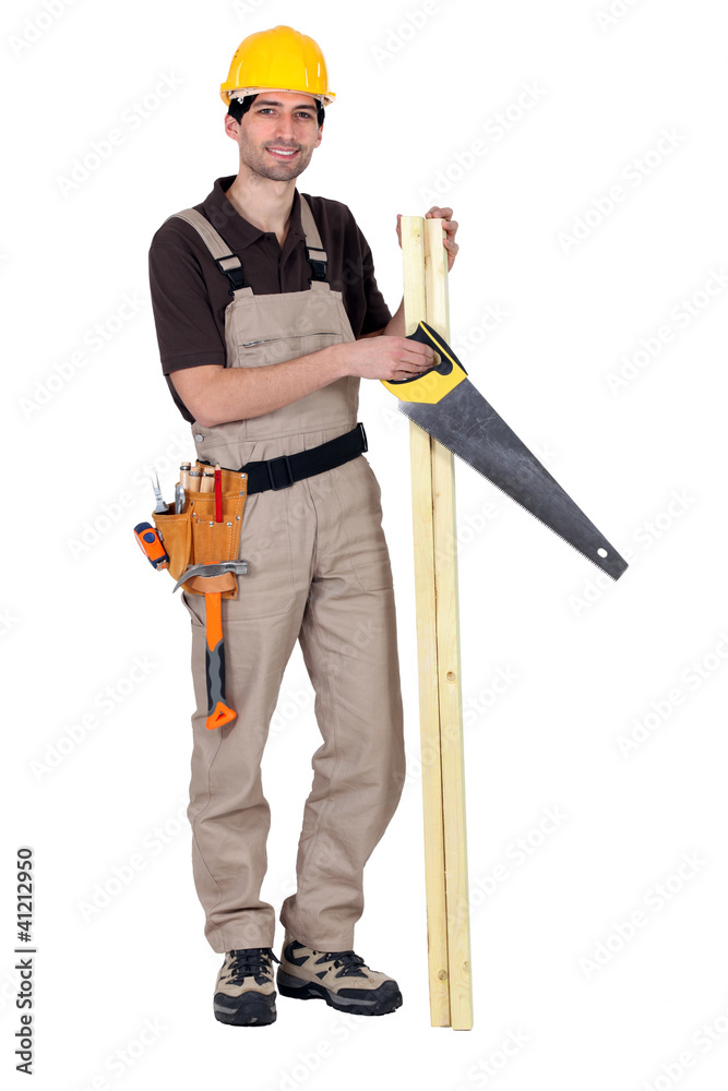 Worker holding plank of wood and hand-saw Worker holding plank of wood and hand-saw