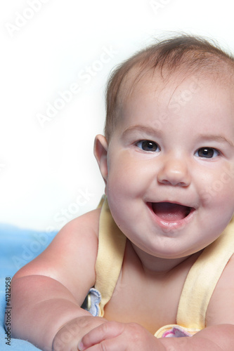 studio portrait of smiling baby over white