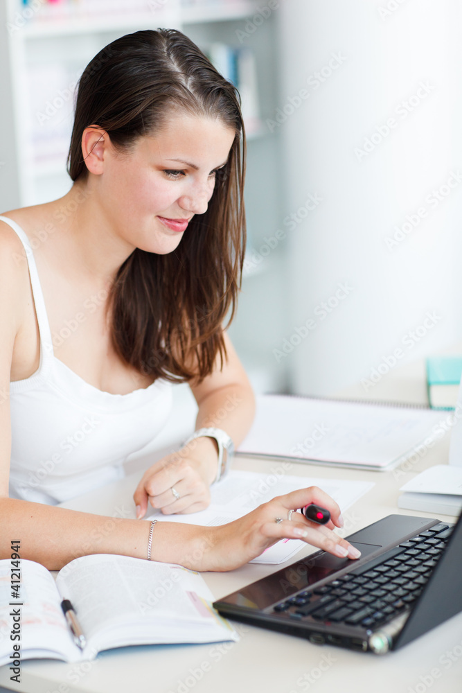 pretty female college student studying in the university library pretty female college student studying in the university library