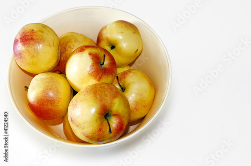 apples in a fruit basket isolated on white