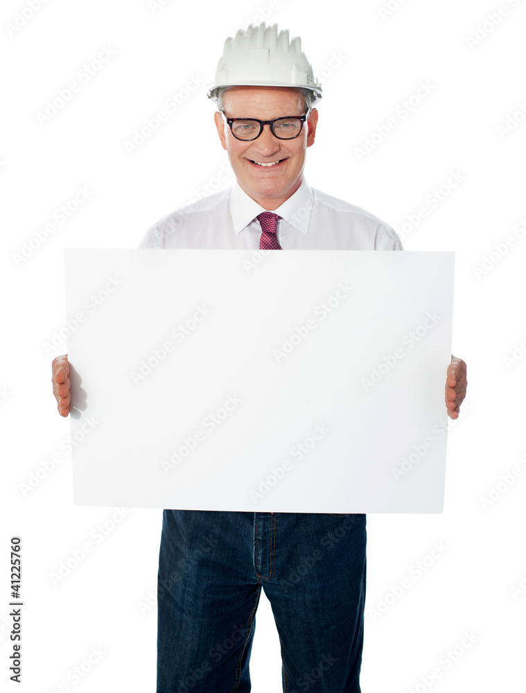 Businessman architect holding a blank white signboard Businessman architect holding a blank white signboard