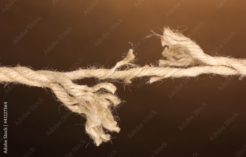 Breaking rope on brown background Breaking rope on brown background