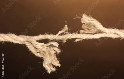 Breaking rope on brown background