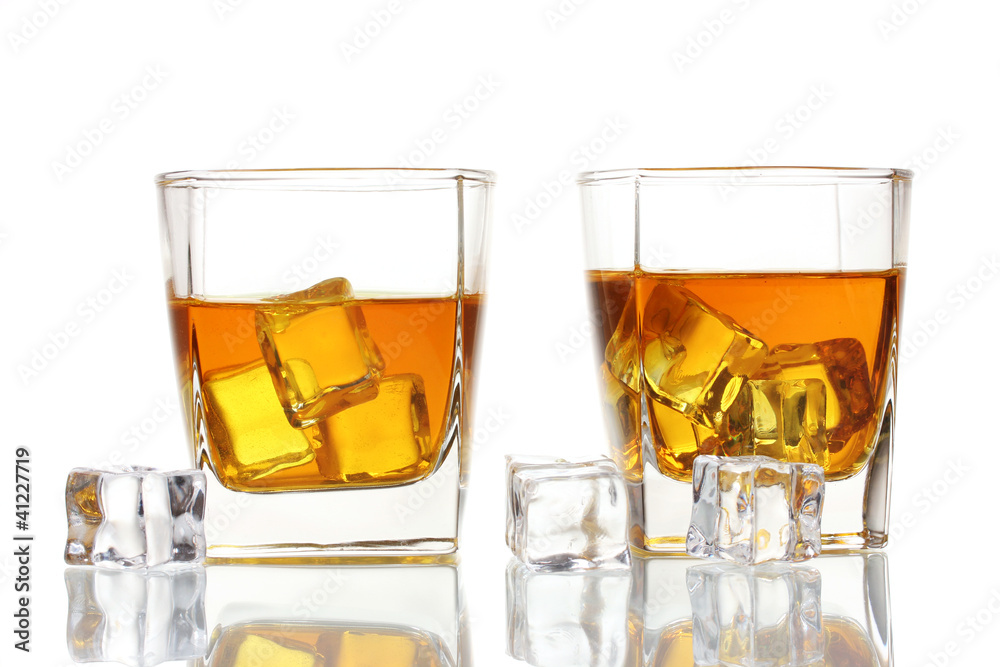 two glasses of scotch whiskey and ice isolated on white two glasses of scotch whiskey and ice isolated on white