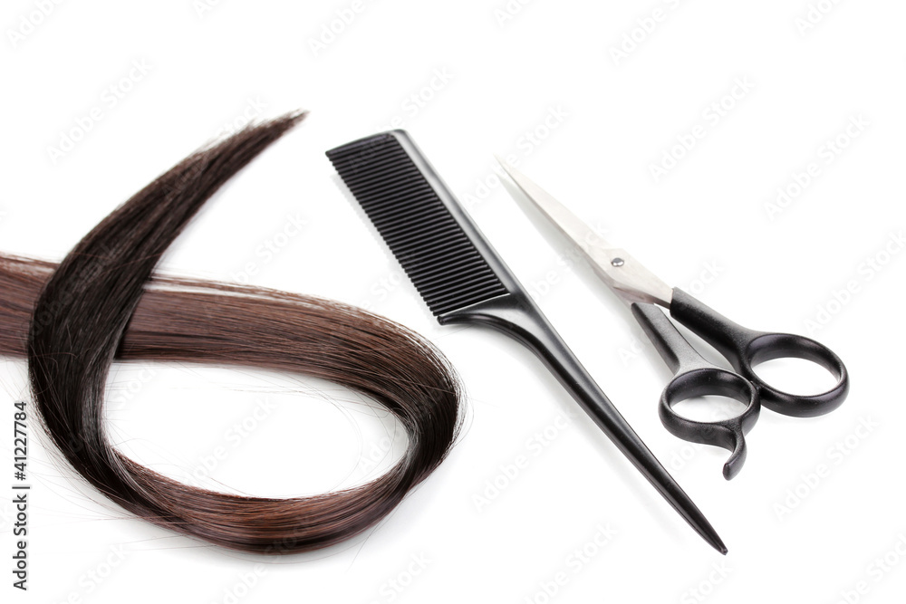 Shiny brown hair with hair cutting shears and comb isolated Shiny brown hair with hair cutting shears and comb isolated