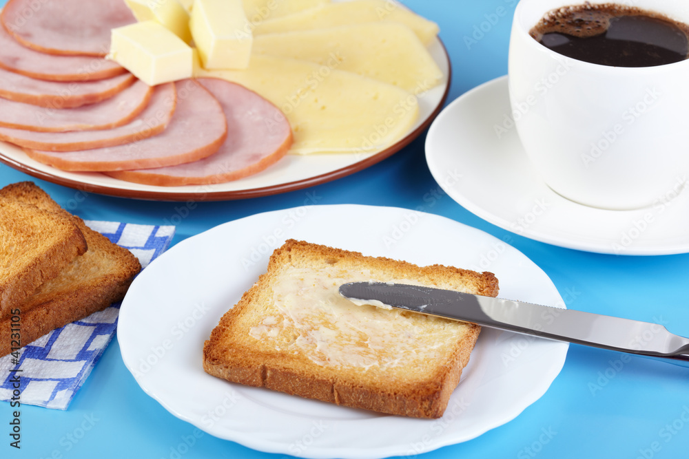 Breakfast. Cup of coffee and toasts with butter, cheese and ham Breakfast. Cup of coffee and toasts with butter, cheese and ham