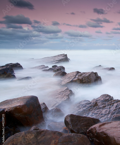 long exposure of misty sea and rocks
