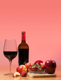 Red wine bottle and fruit with glass