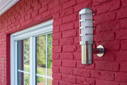 lantern outside the house next to a window