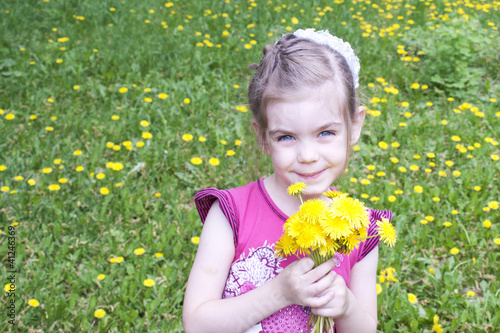 Young girl in a field of dandelions