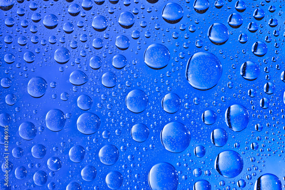 Blue water drops on the glass Blue water drops on the glass