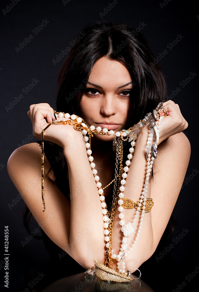 Portrait of beautiful young woman with Golden jewelry