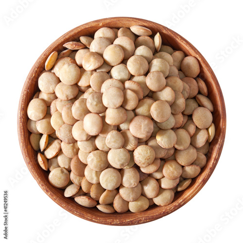 wooden bowl full of laird lentils isolated on white photo