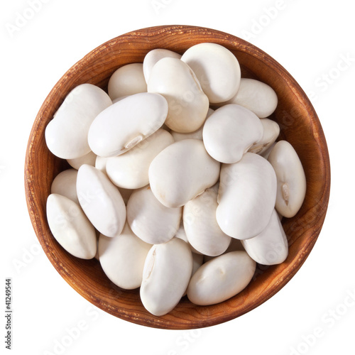 wooden bowl full of white beans isolated on white