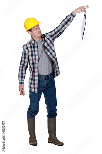 A repulsed tradesman dangling a clipboard
