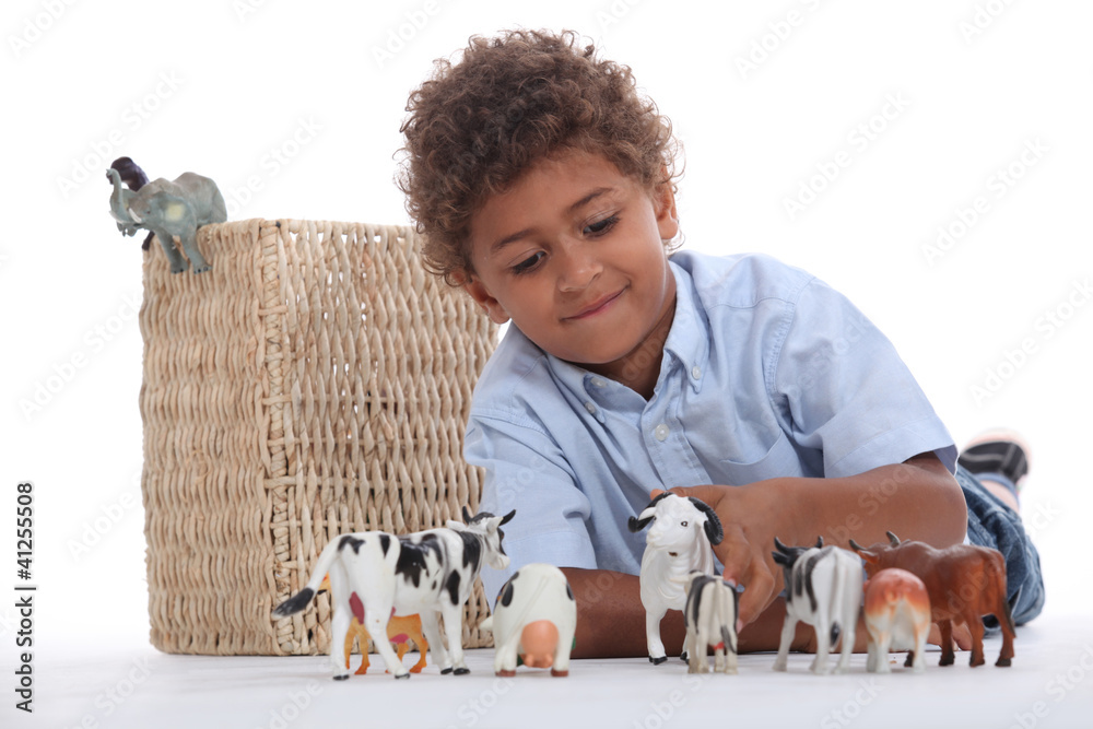 Little boy playing with his toy animals Little boy playing with his toy animals