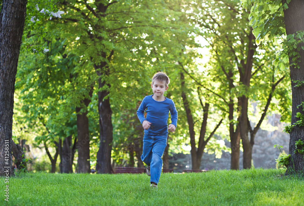 happy little boy raning on the grass happy little boy raning on the grass