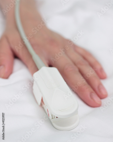 pulse oximeter on the patient's hand. Medical background. photo