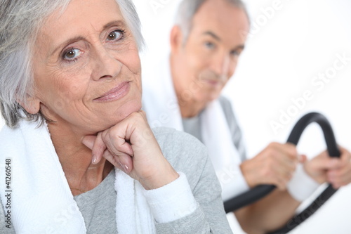 elderly lady posing in fitness center with husband