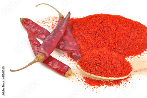 powdered and whol red chili on white photo